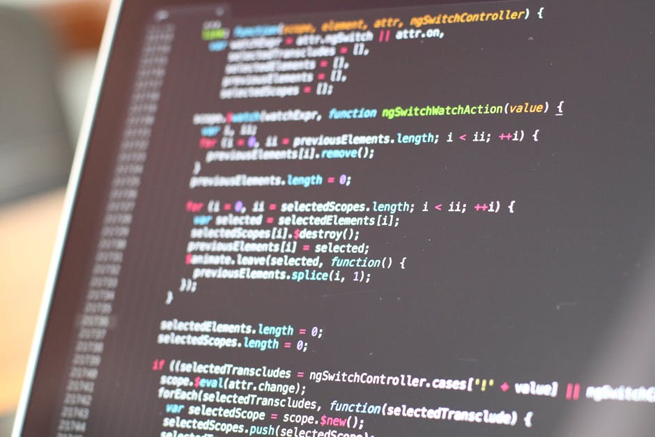 A close-up view of a computer screen displaying lines of colorful programming code, with various syntax highlighting in shades of pink, blue, green, and white on a dark background. The code appears to